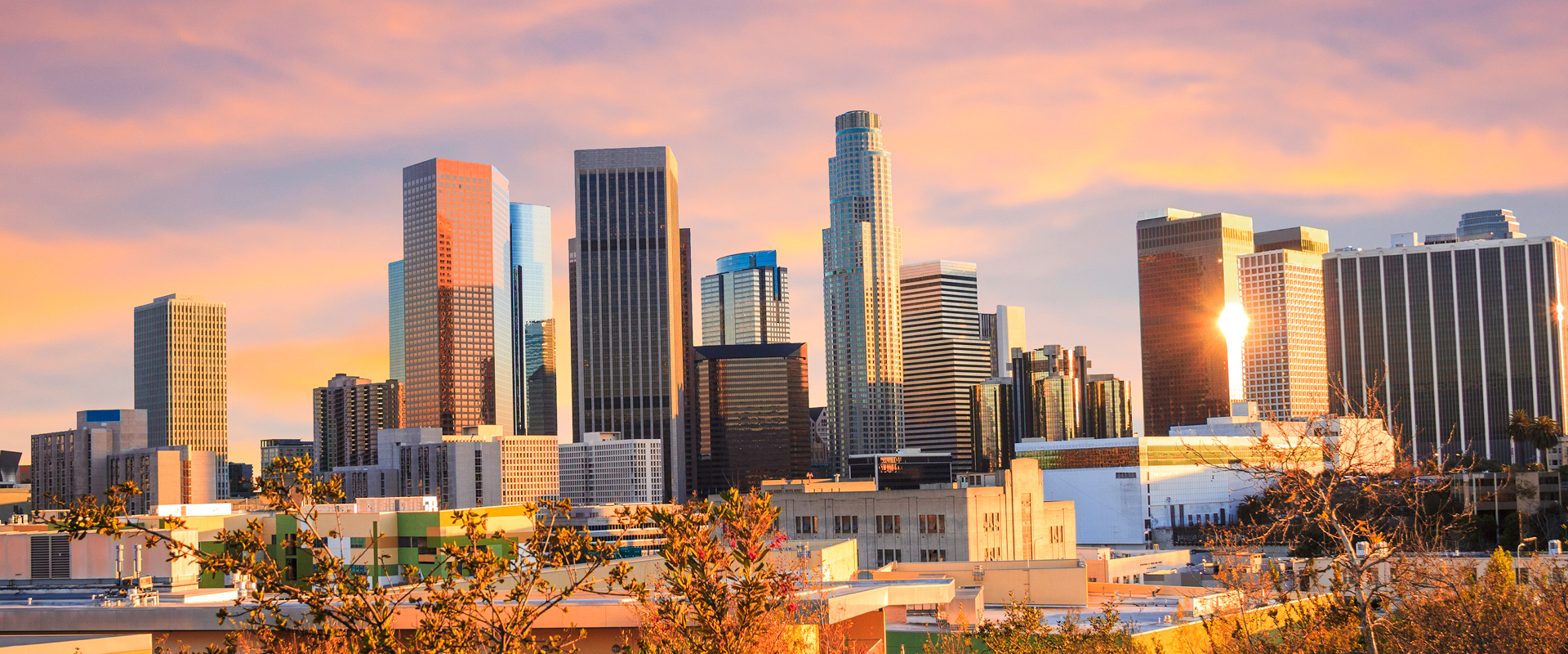 sun setting on Los Angeles CA city skyline