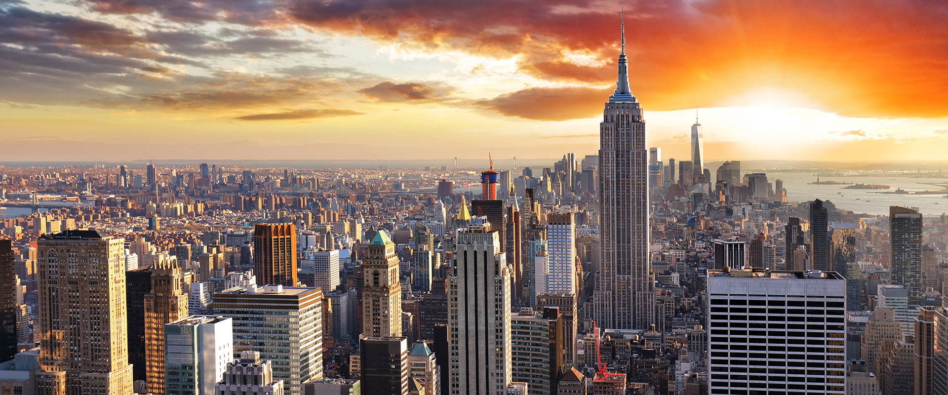 New York city skyline (POV from sky with orange sunrise in background