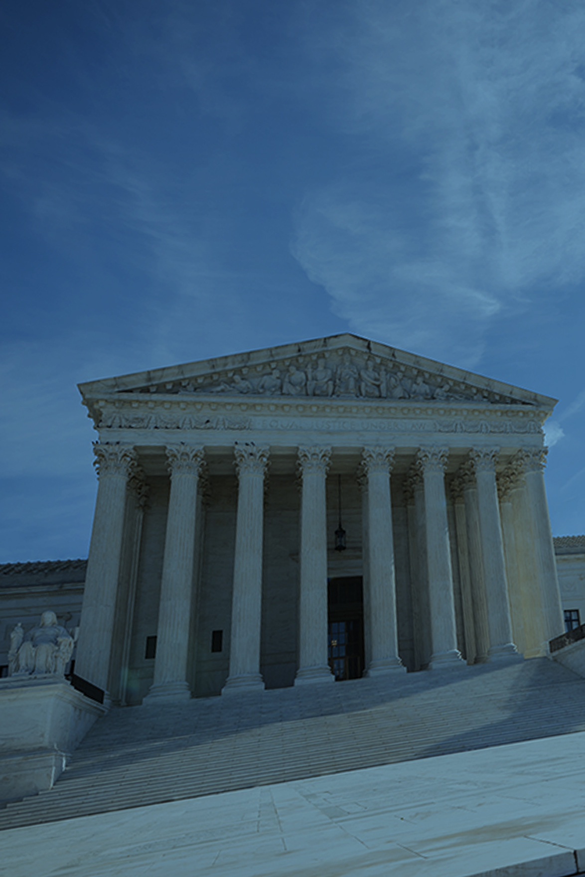 image of supreme court with blue sky behind