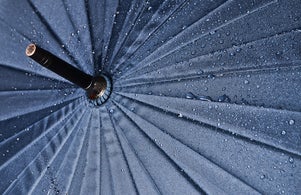 Umbrella in water drops