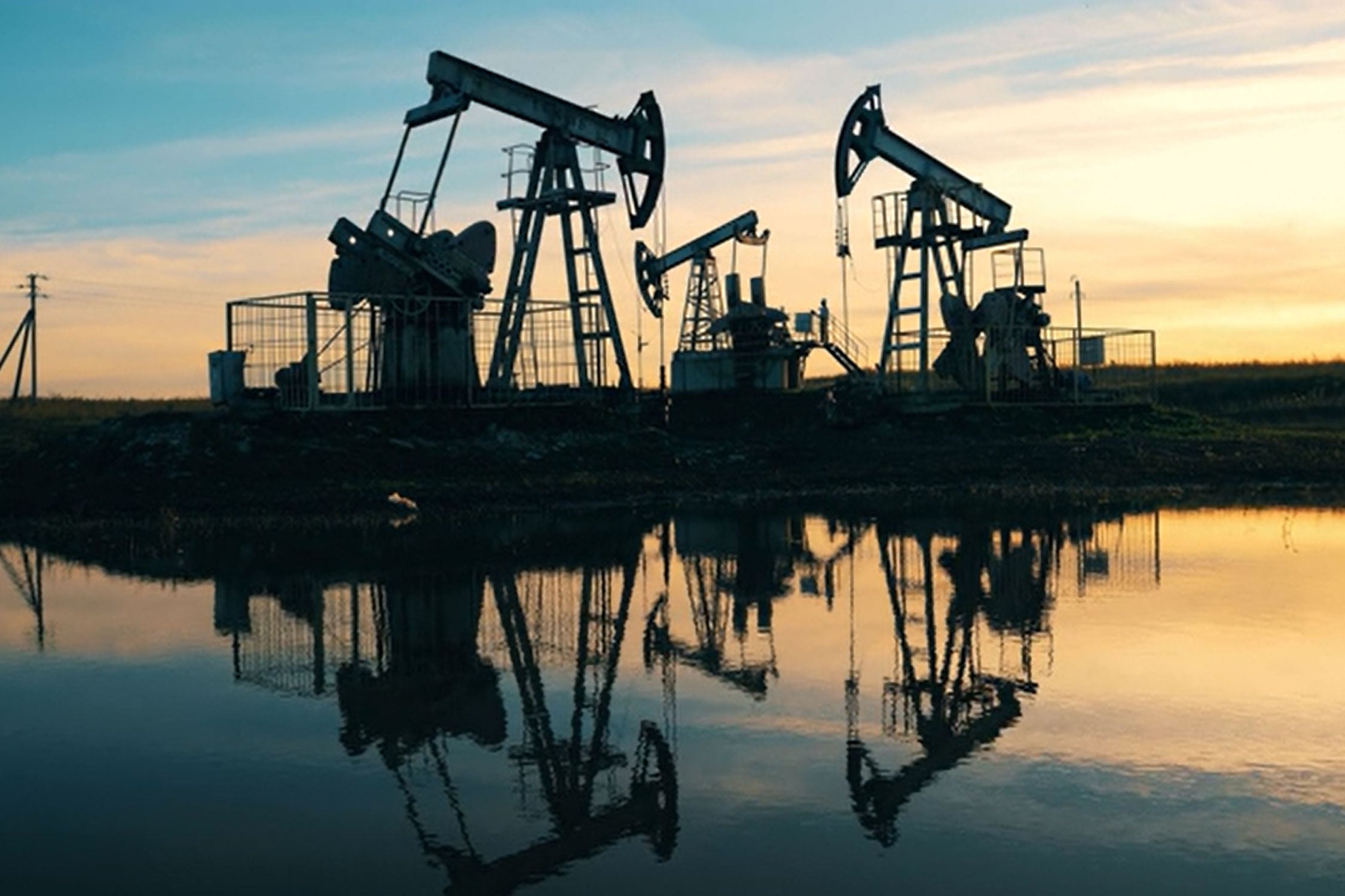 oil and gas field with sunset behind