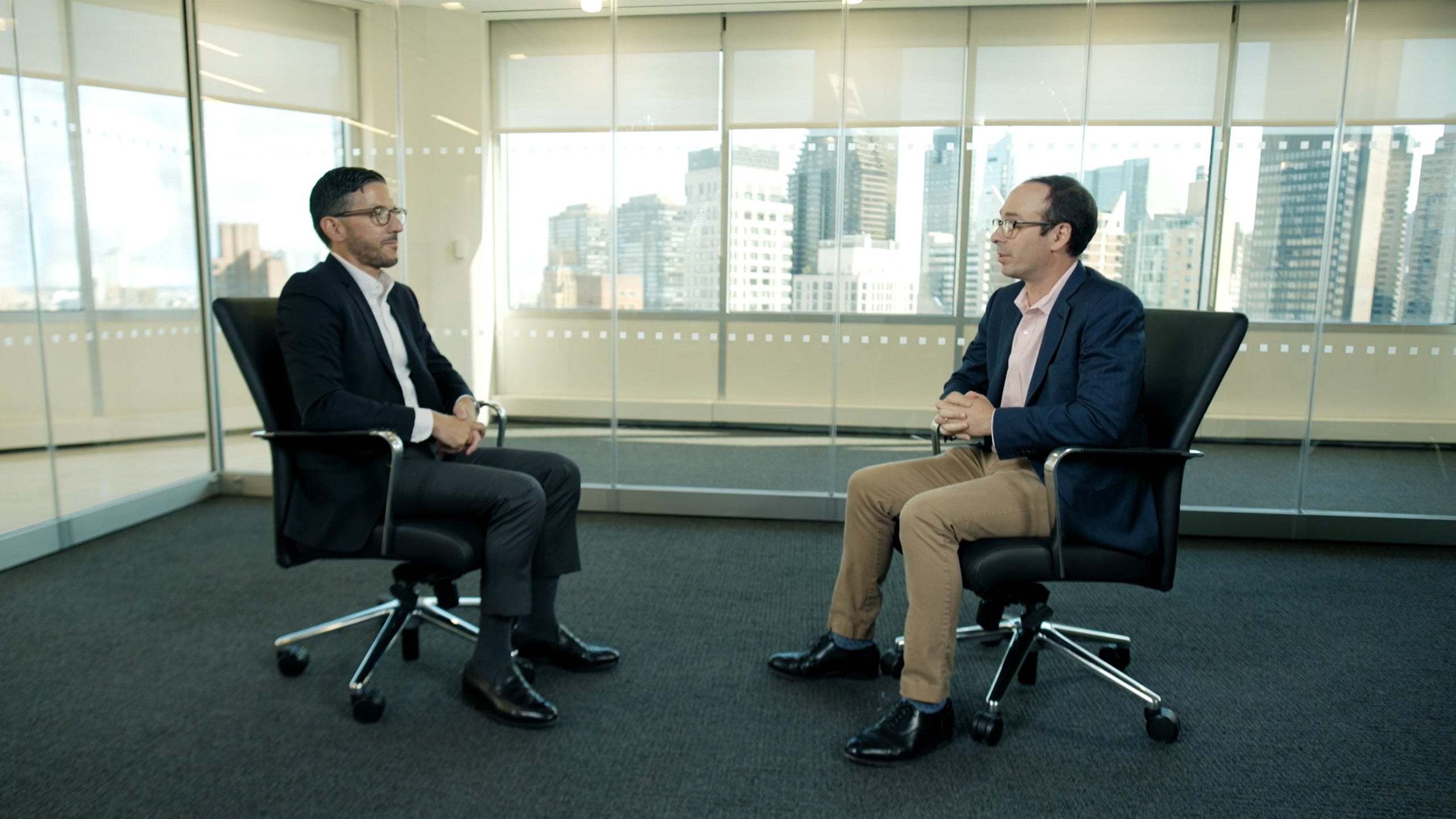 Photo of Troutman Pepper Locke attorneys John Emmanuel and Zachary Lerner having a conversation while sitting in chairs.