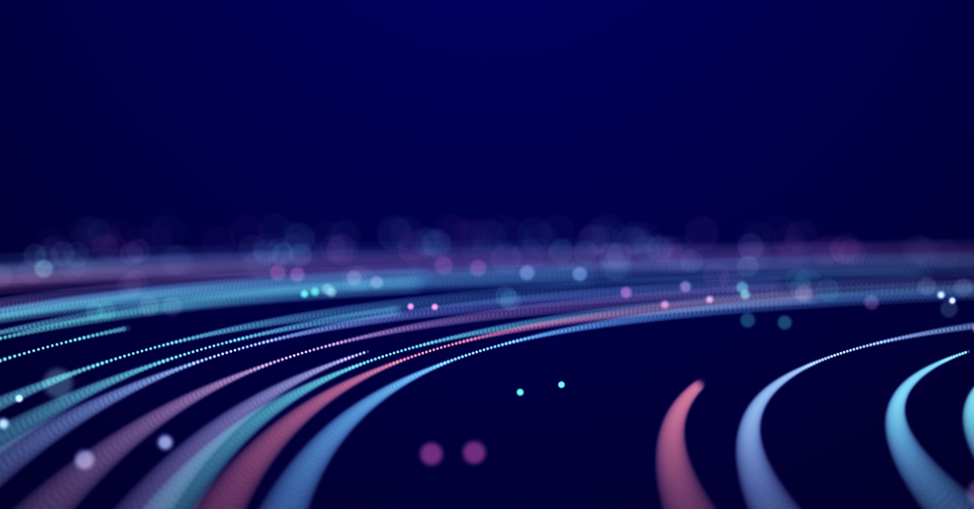 Abstract digital image featuring curved lines made of small glowing dots in blue, purple, and pink tones, set against a dark blue background. The lines create a sense of motion and depth, resembling data streams or fiber optic cables.