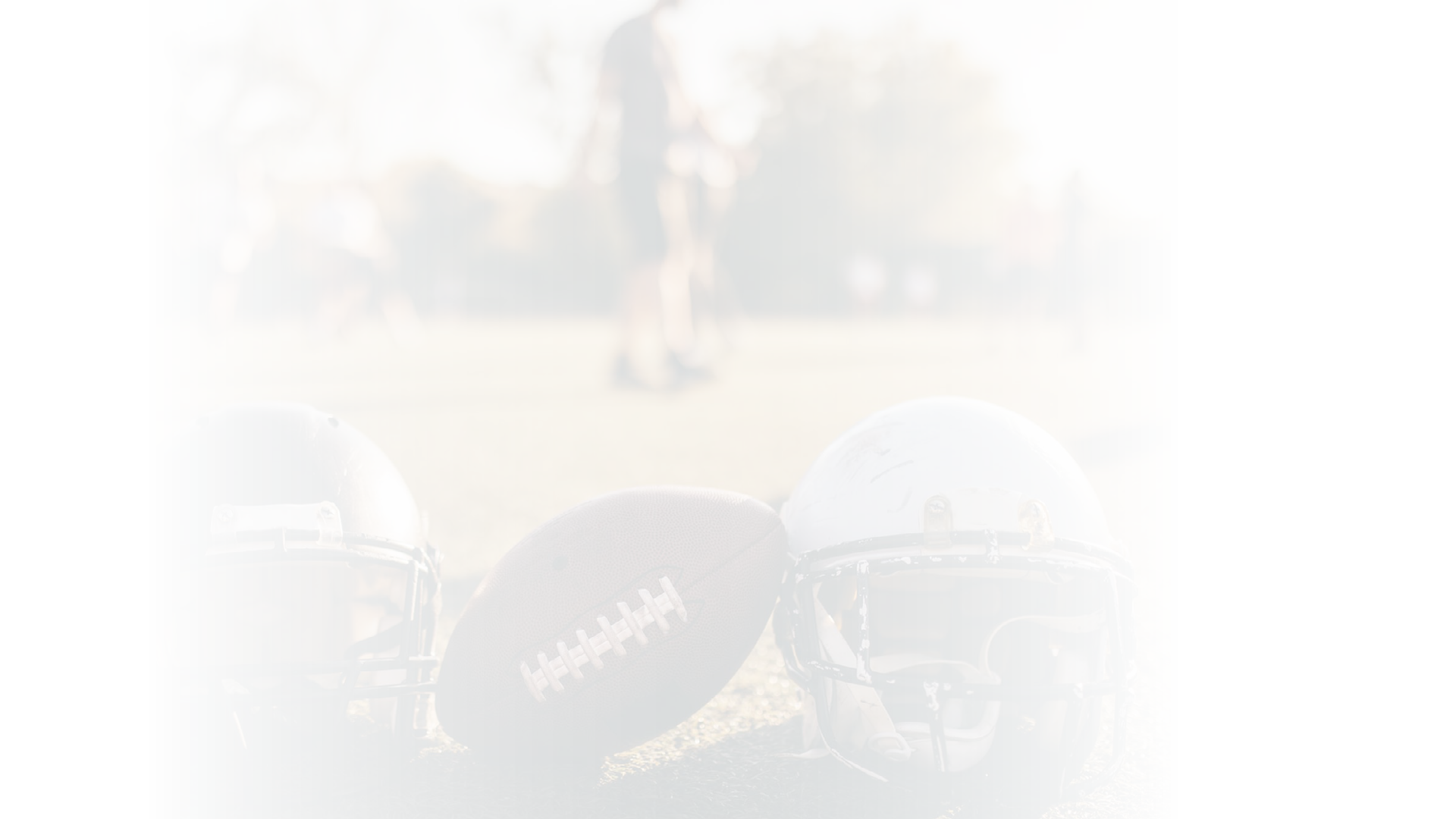American football helmets and ball on the playing field.