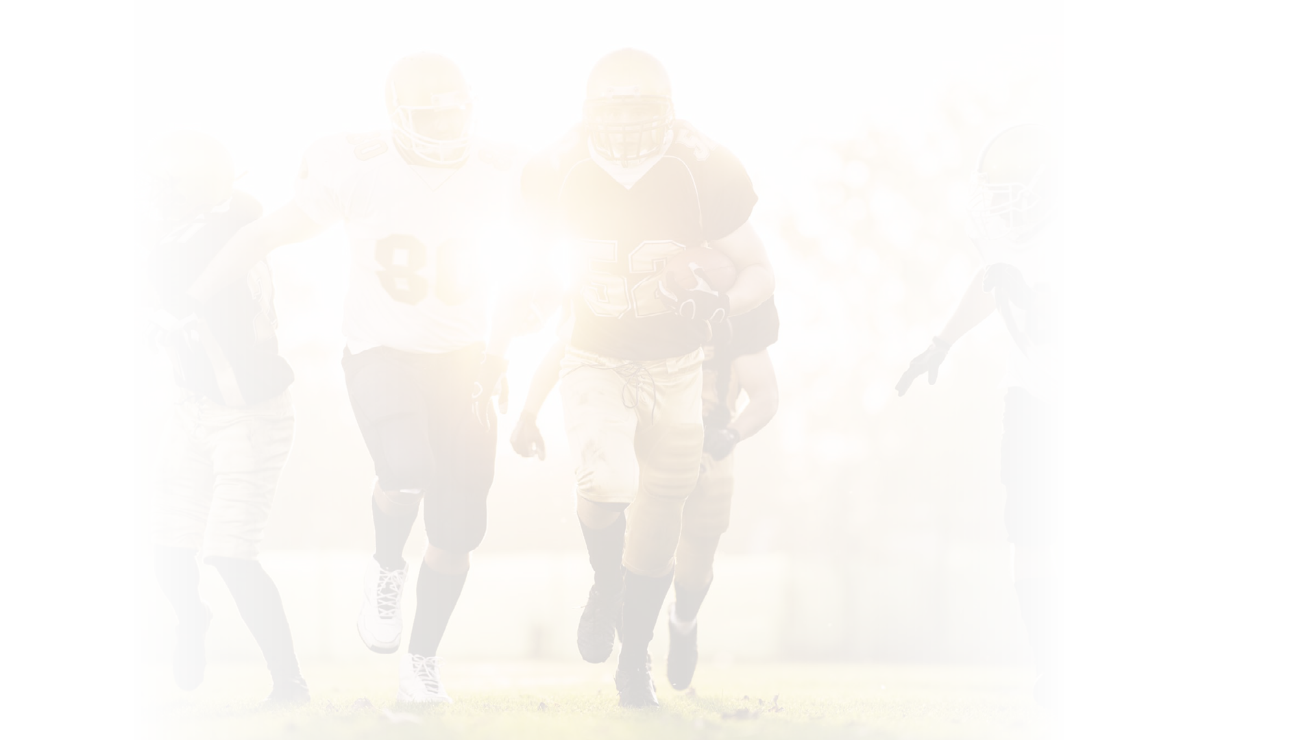 American football players in action on the playing field.