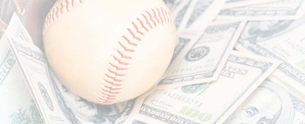 Closeup concept of baseball and money.