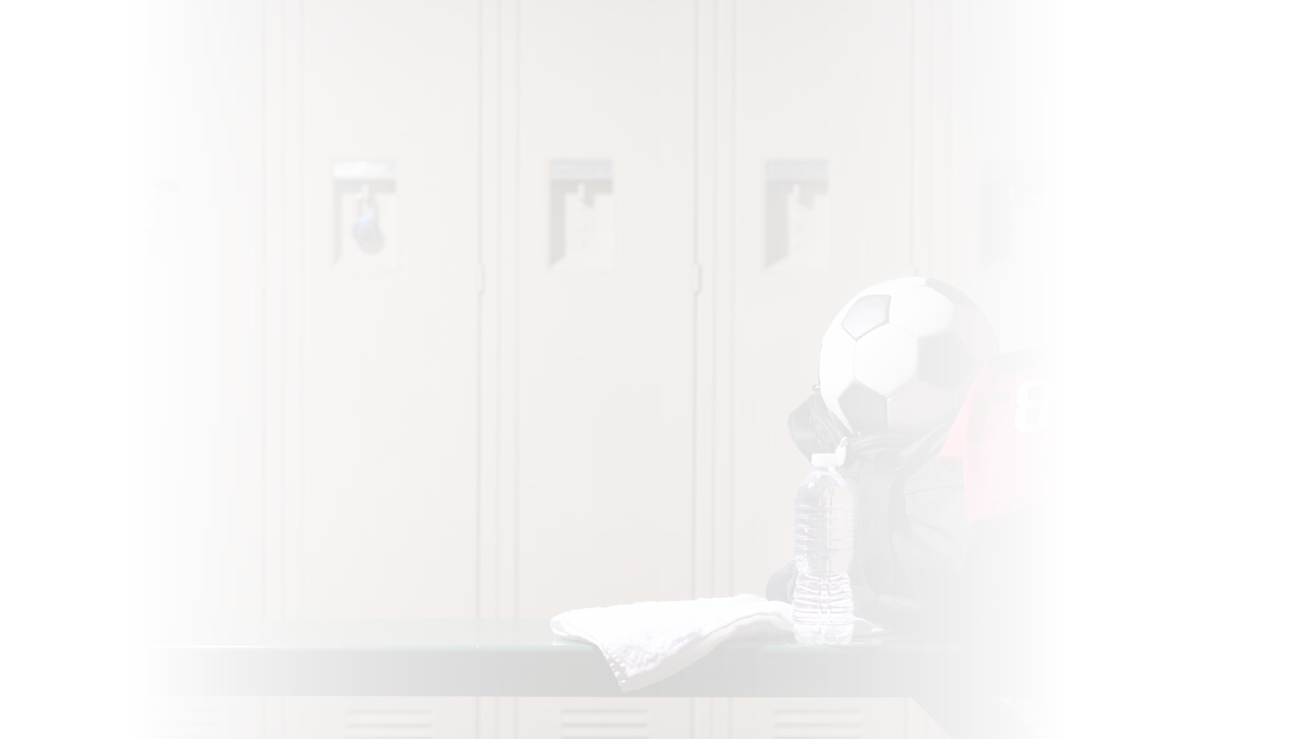Various sports equipment on bench inside high school or college gymnasium locker room.  Items include: basketball, jersey, water, towel, gym bag..